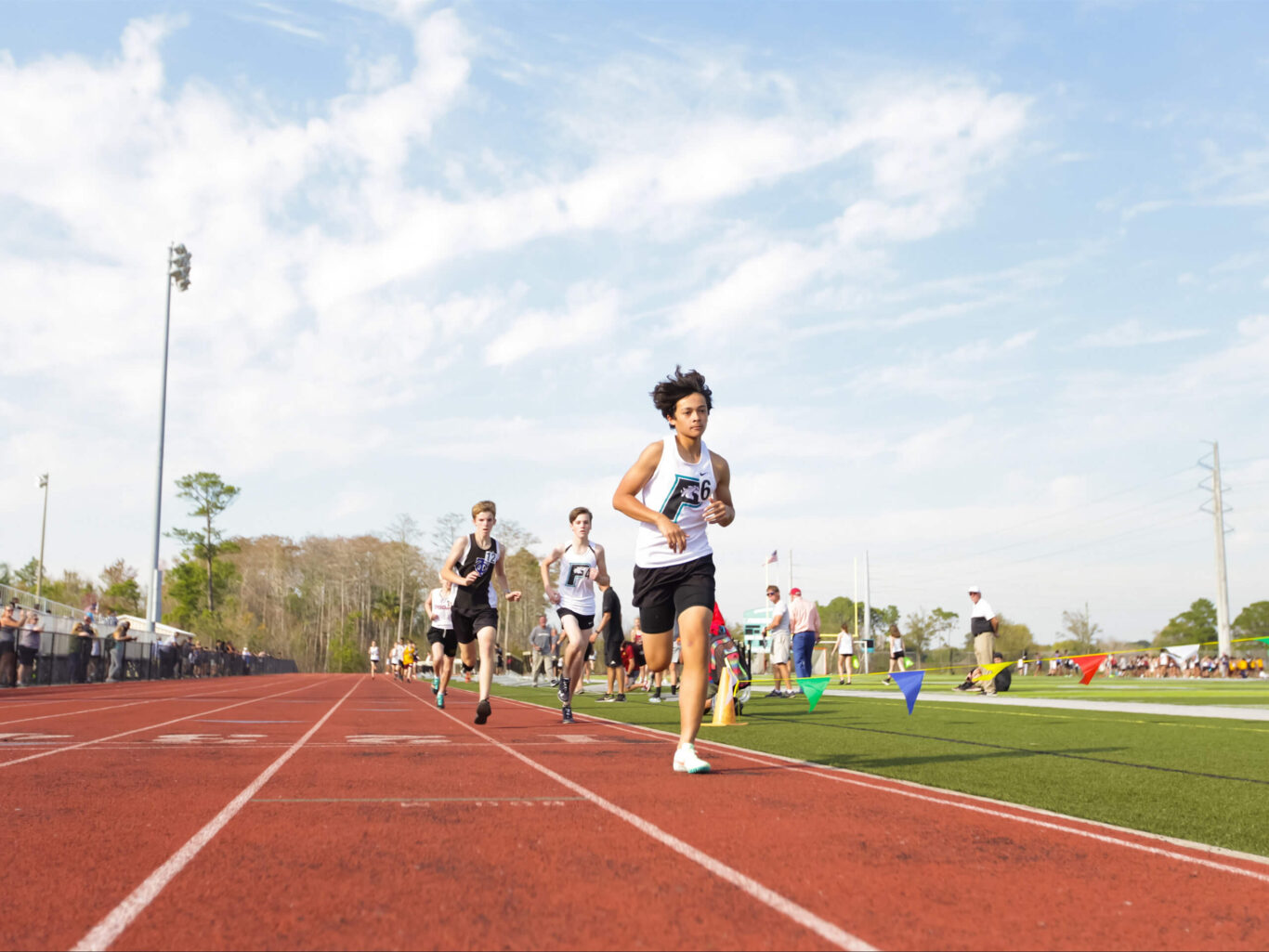 A group of boys running on a track.