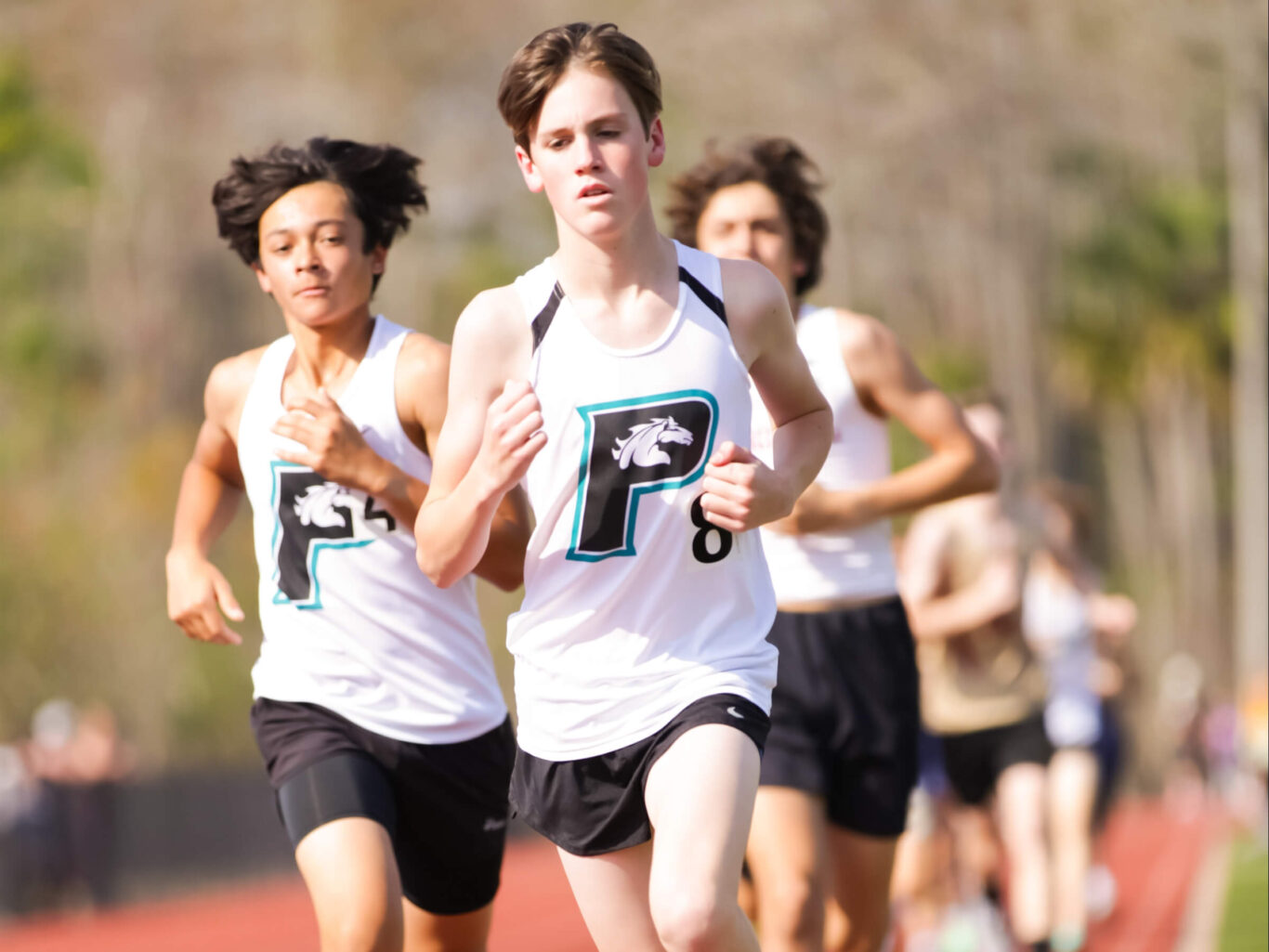 Two boys participating in a track and field race.