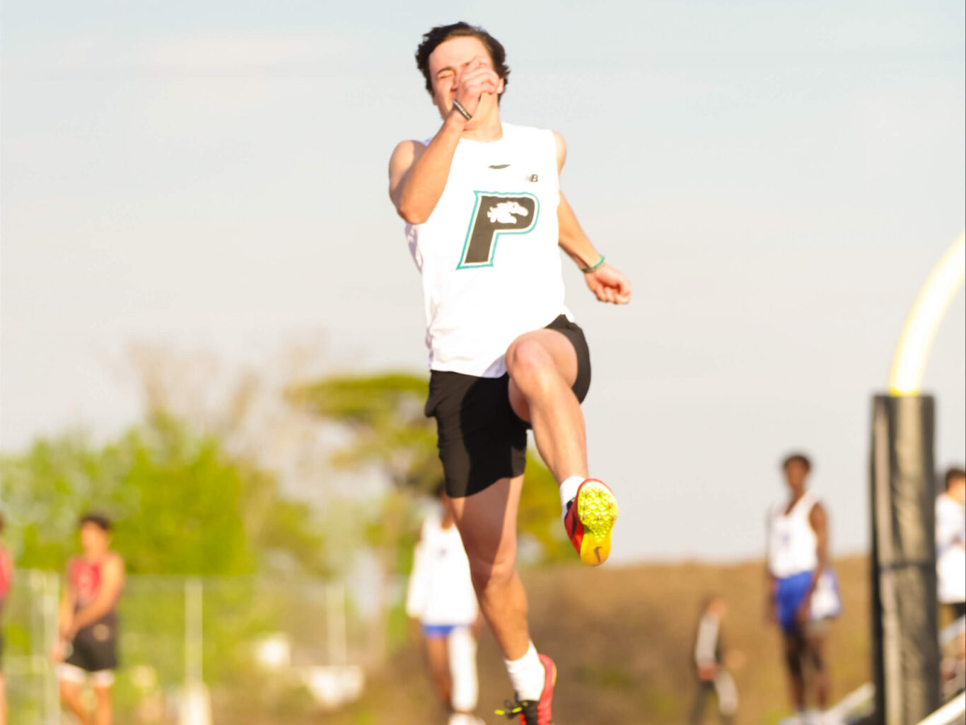 A young man competing in a track race.