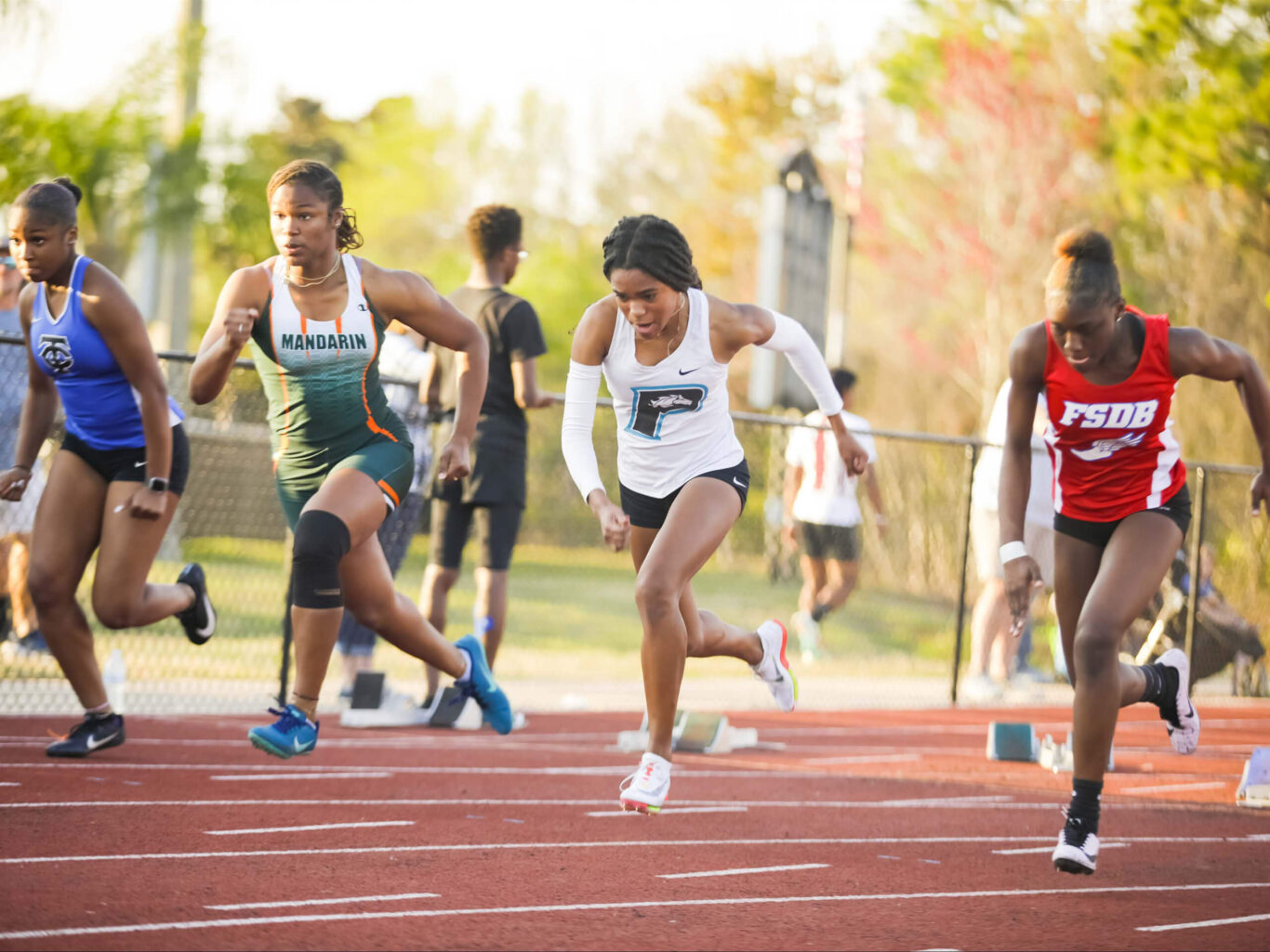 Girls are running on a track.