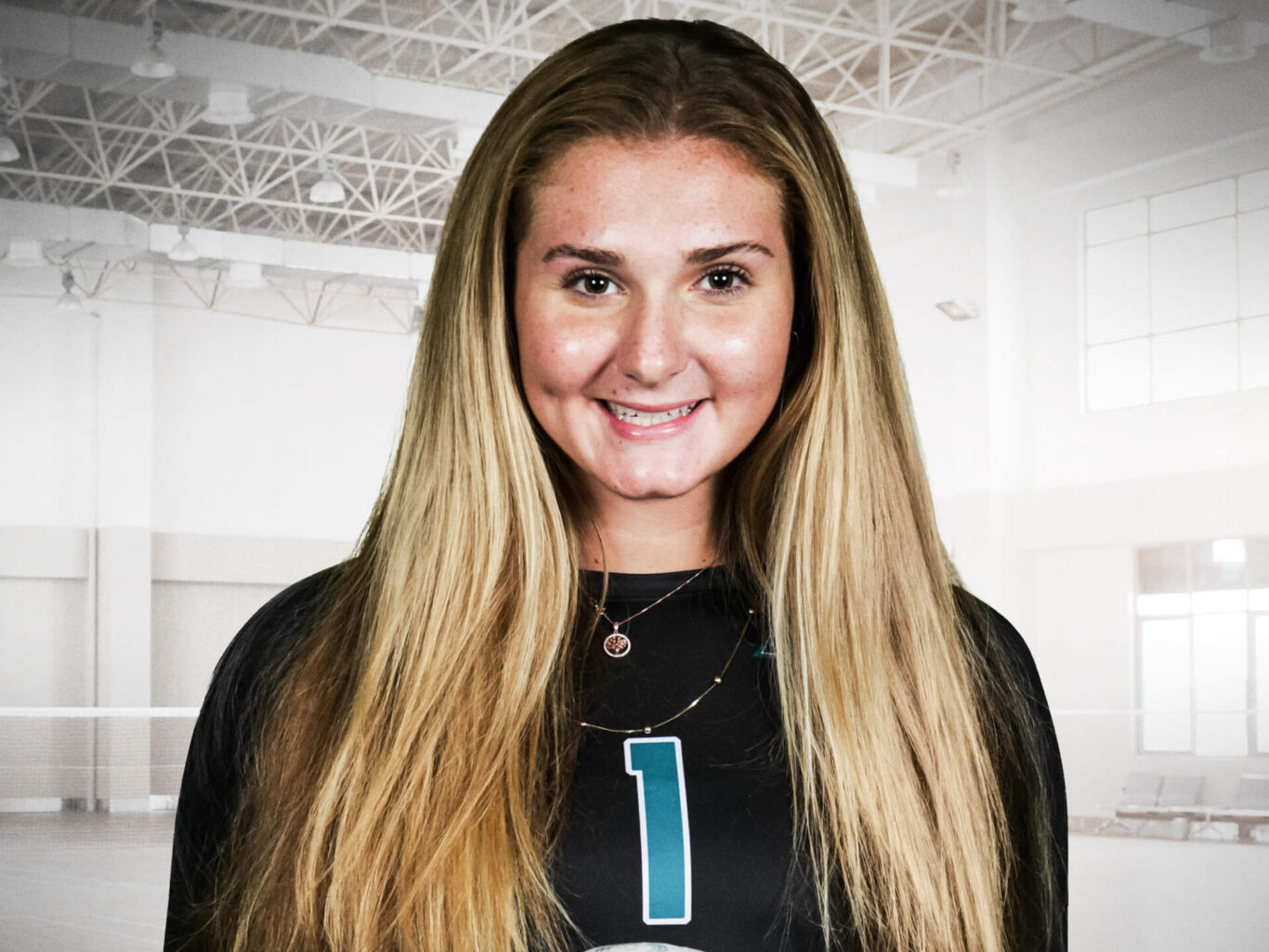 A female volleyball player is posing for a photo during a volleyball game.