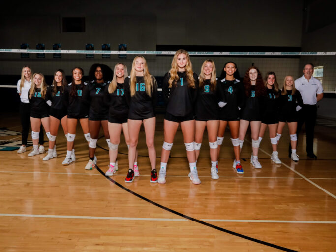 A group of girls playing volleyball.