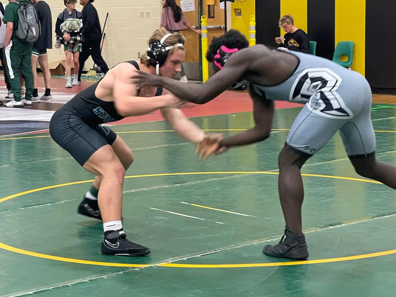 Two boys engaging in a wrestling match.